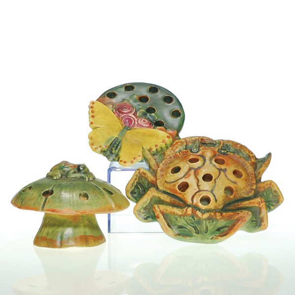3 Weller Muskota frogs, Butterfly, crab, frog: Weller lot of three flower frogs: A 1 1/4 iby 3 3/4 inches, crowned with a butterfly and flowers; unmarked; small chip to base; second is 1 3/8 by 5 inches, graced with a crab; marked Weller in block 