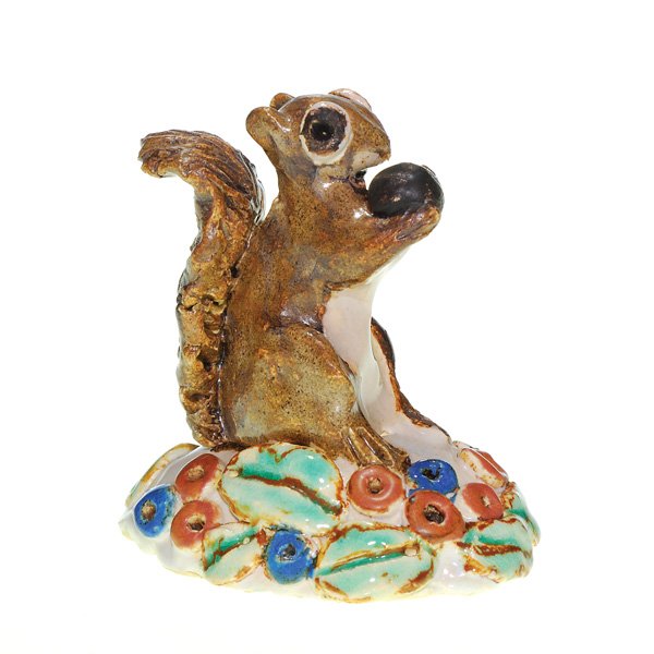 Overbeck grotesque squirrel, 2 1/2”: Overbeck Pottery “grotesque” figure of a squirrel standing on a flower covered mound, happily munching on a nut. Lightly impressed with the Overbeck logo. In excellent, original condition. Height 