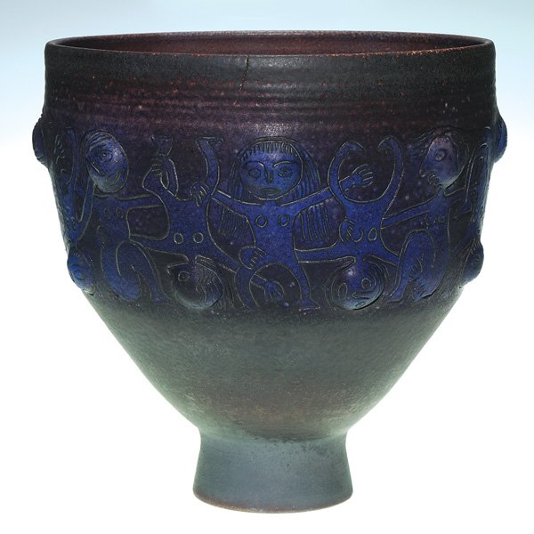 Large Scheier bowl, purple, human figurures: Large Edwin Scheier bowl encircled with human figures in alternating positions with arms linked and covered with a deep purple glaze. Incised 91-Scheier on the bottom. There is a 1 3/4 inch firing sep