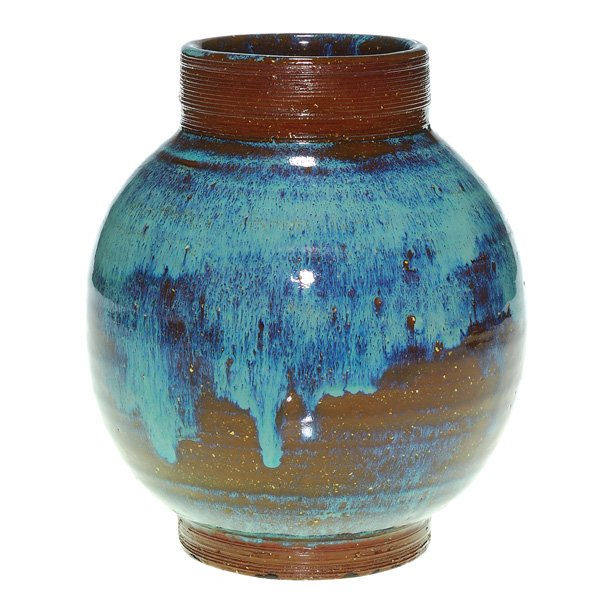 Newcomb vase, thrown, brown & blue glaze, 6 1/2": Newcomb College hand thrown vase covered in a chocolate high glaze then clothed in moonlight blue over a global ridged body, possibly the work of Joseph Meyer. The artist applied a nice combed pattern