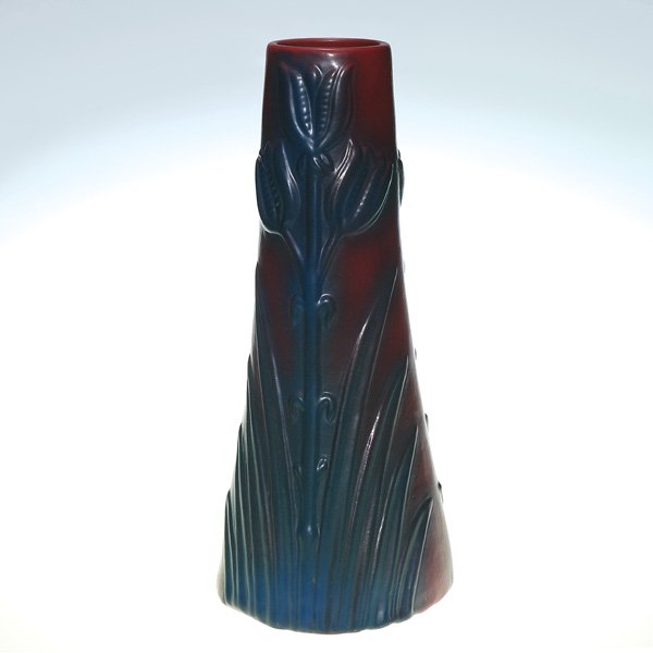 Van Briggle Mulberry glaze vase, tulips, ca 1920’: Tall Van Briggle vase with deeply embossed stylized tulips made in the 1920’s. Incised Van Briggle logo and “Van Briggle Colo Spgs.” Height 16 inches. Professional restoration to base chips.