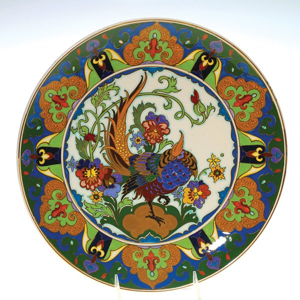 Amphora Holland charger, Golden Pheasant, 12 1/2": Amphora Holland high glaze charger depicted with a handsome Golden Pheasant strutting through a patch of colorful pansies. The border is decorative with multicolor designs. Diameter 12 1/2 inches. Han