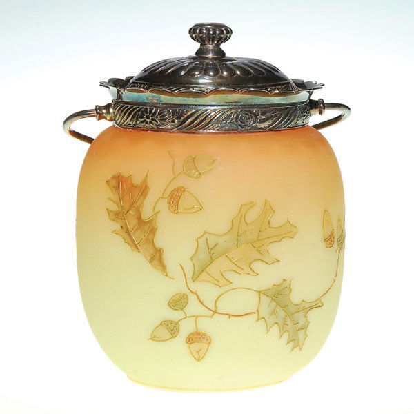 Mt Washington cracker barrel, oak bough, 7 1/4”: Mount Washington cracker barrel with a bough of oak leaves and acorns set against a faux Burmese backdrop. The cover has the logo of Pairpoint within. Combined height 7 1/4 inches. Misses of the raise