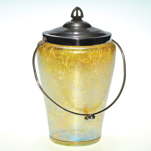 Loetz biscuit barrel, Candia Papillon, 8 1/4”: Loetz biscuit barrel in gold with the firm’s Papillon pattern. An added feature, the base area was wheel cut allowing for the application of a thin metal band to fit snug. Height 8 1/4 inches. A hal