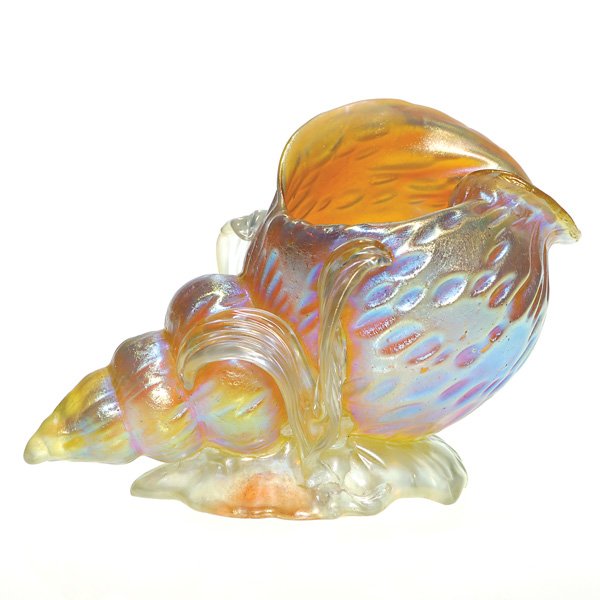 Loetz conch shell w/seaweed, Diaspora, 3 3/4": Loetz conch shell settled within several blades of ocean seaweed. The golden shell was created with the Diaspora pattern, the impressions highlighted with a lovely purple blue. There is a one inch rep