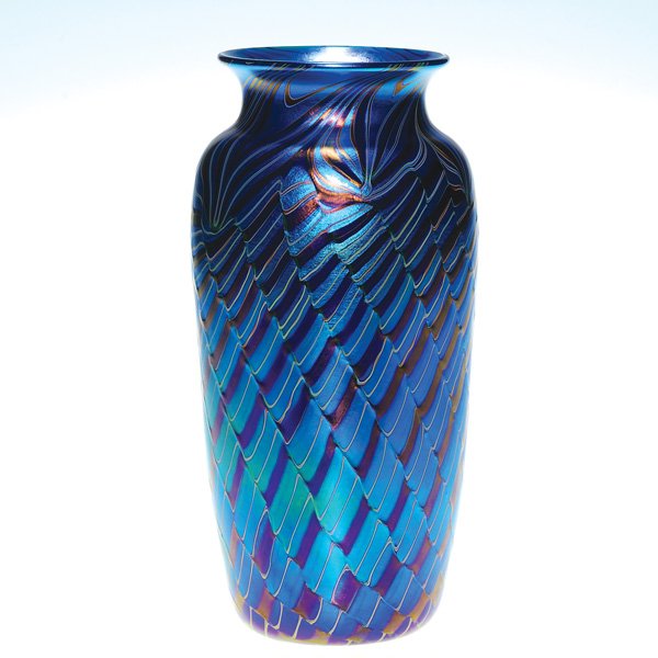 Orient & Flume “Ribbed Twist” vase, blue, 9 1/8”: Orient & Flume “Ribbed Twist” vase in shades of aurene blue with mesmerizing patterns of pulled leaves about the shoulder and a “rippling water” effect combined with raised reverse swirl on th