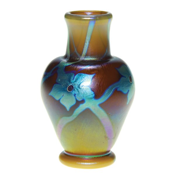 Mini Lundberg Tiffany style vase, 3”, M. Cantor: Early miniature Lundberg Studios vase in the style of Tiffany by artist Mark Cantor. The iridized caramel body is decorated with three blue aurene flower heads and trailing vines. Height 3 inches. The