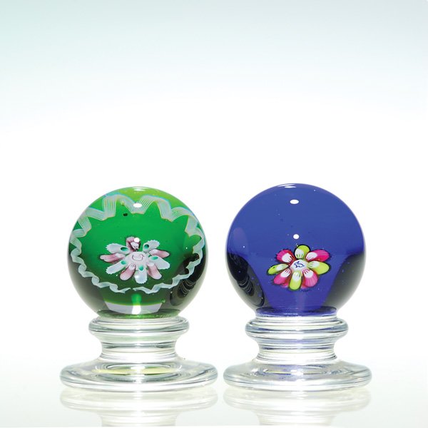2 Mini Kazium “animal” pedestal paperweights,1 7/8: Two miniature Charles Kaziun Jr “animal” pedestal paperweights showing either a rabbit or a duck centered within pastel flowers. Height 1 7/8 inches. A white filigree border to one. The gold “K�