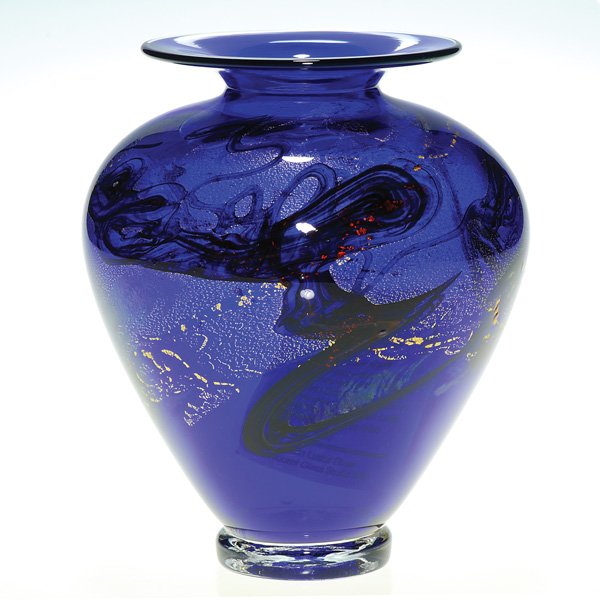 Nourot cobalt vase, gold inclusions, 7”, signed: Nourot Glass Studio cobalt blue vase wrapped with patches of gold about the shoulder with a meandering vine wondering through. Steadied upon a clear disc base engraved with the company name, the initi