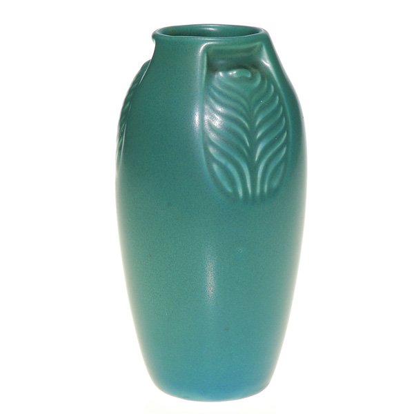 Rookwood gray-green mat “Peacock Feather” 6” vase: Production 6 inch Rookwood vase with three panels, each highlighting a peacock feather, cast in 1921 and covered with a gray-green mat glaze. Impressed with the company logo, the date and shape 2402.
