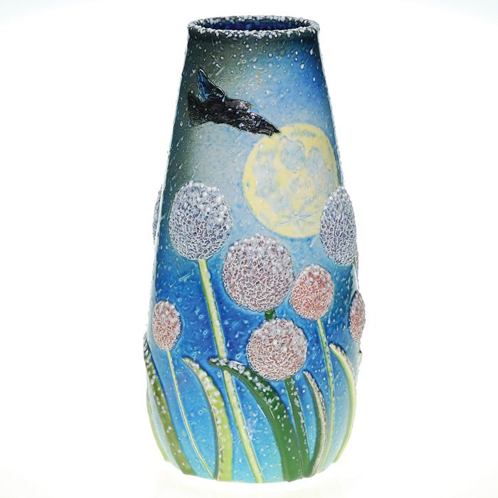 Tim Eberhardt vase, Rooks,flowers & moon, 11 1/2": Charming vase crafted by contemporary potter Tim Eberhardt, who encircled the vase with puffy flowers with sharp, lizardlike fronds, above which fly two black rooks under a blue sky with white flecks,