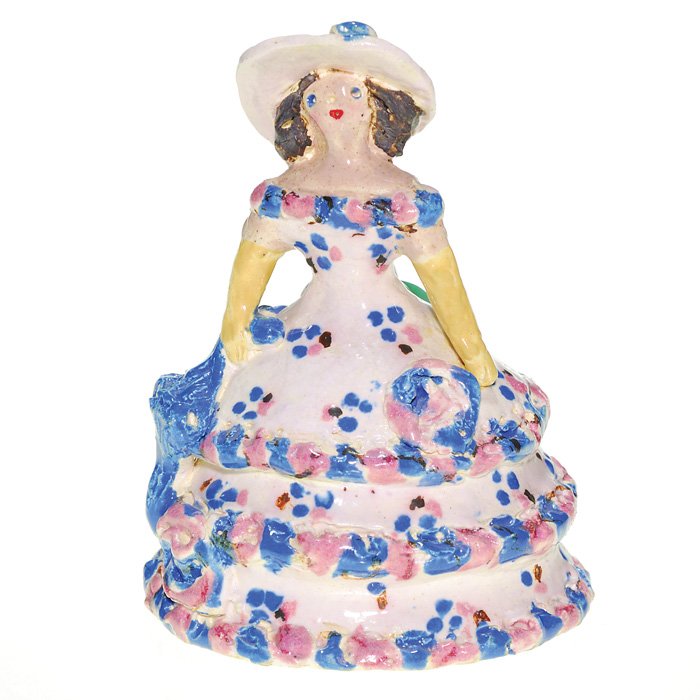 Overbeck figurine “Southern Belle” 4 1/4”: Overbeck Pottery “grotesque” figure of a Southern Belle, wearing a dress with a hoop skirt and a broad brimmed hat, in complementary colors of blue, pink and white. Impressed with the Overbeck log