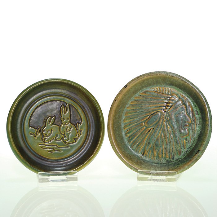 2 UND coasters: Indian Chief, Rabbits, 3/4” X 4”: Lot of two UND coasters: The first, a Huckfield design, features the portrait of a Native American, in headdress; incised University of North Dakota H-20; the second shows two rabbits; marked with the