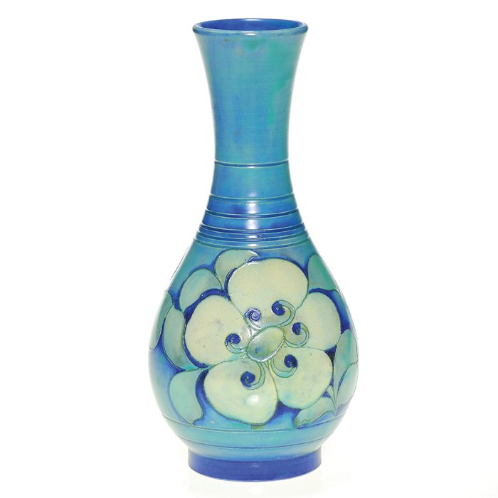 Moorcroft 8 1/2” Art Deco vase, stylized flowers: Moorcroft vase graced with two large, stylized flowers, much in the Art Deco style and done in mat glazes. Marked with the impressed Moorcroft signature, the Made in England mark and the “painted in