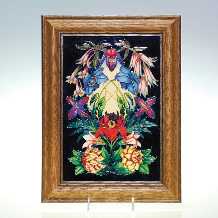 Moorcroft 12” X 8.25” floral plaque, 2004,: Moorcroft plaque with a lush, colorful floral design created by Philip Gibson and made in 2004. The charming variety of flowers is enhanced by being set against a black ground. Marked with the Moorcro