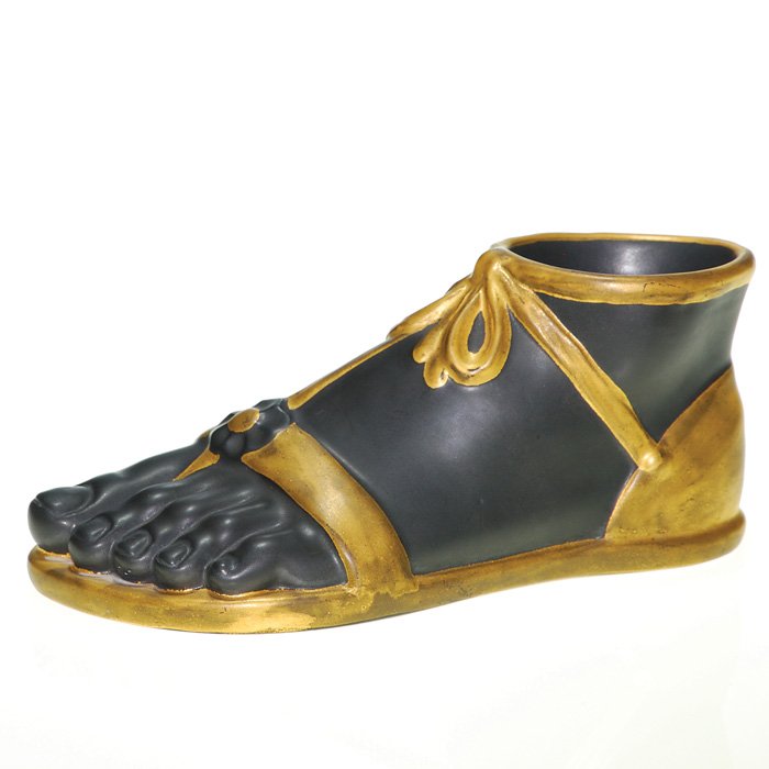 Fornasetti sandal “foot” ornament, 3 1/2”X9”: Itallian Fornasetti life size porcelain “foot” bound with a strap sandal and covered in black and gold glazes. Height 3 1/2 inches by 9 inches long. Unmarked. Excellent original condition.
