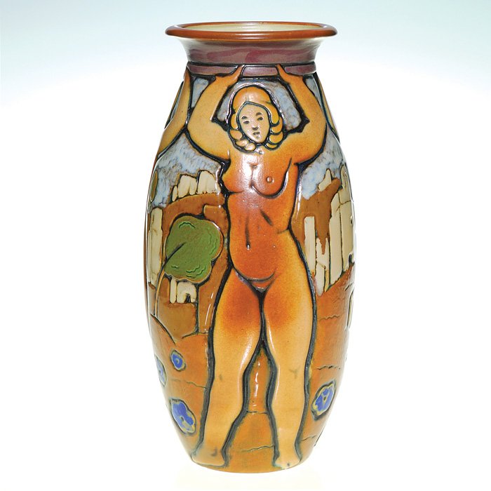 Mougin polychromed 13” vase, nudes: Mougin Pottery vase encircled by three evenly-spaced female nudes holding an object aloft with a barren appearing town in the background. Marked on bottom Mougin, Nancy, 288 J, Legland, JC, an L and 0