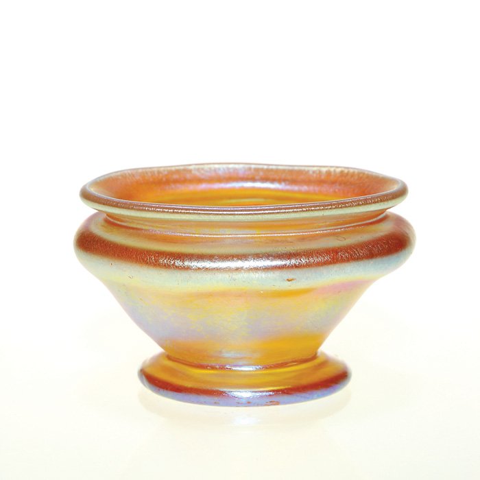 Tiffany footed salt cellar, ribbed, 1 3/8”, sig: Good Tiffany salt cellar, ribbed and footed in iridescent gold. Height 1 3/8 inches, diameter 2 1/4 inches. Engraved “L.C.T” on the bottom. Bluish magenta exterior highlights. A little cutie in pe