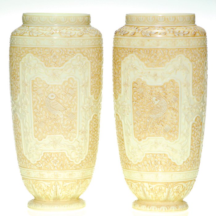 Pair Webb Ivory cameo vases, 8 1/2”, marked: Exquisite pair of Thomas Webb & Sons cameo vases fastidiously carved with an Oriental design from rim to base. The two tone ivory bodies are blanketed with minute leafing vines and flowers surrounding