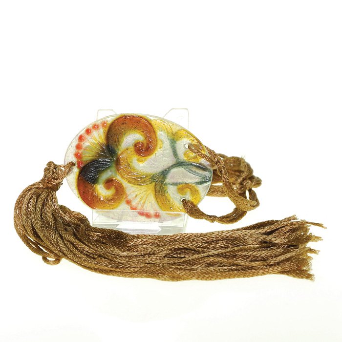 G.Argy-Rousseau pate-de-verre pendant, floral: Gabriel Argy-Rousseau pate-de-verre 2 5/8 inch pendant molded with exotic fuchsia blossoms in amber brown and coral. Golden brown silk tassel and neck cord. Marked “G.A.R.” on the edge. Excellent 