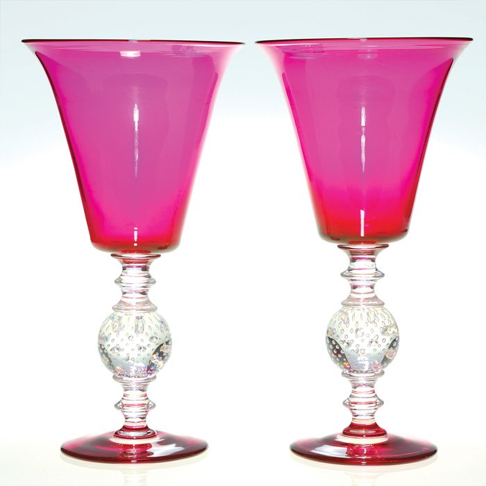 Pr ruby Pairpoint vases, ball stem, 11 1/2": Twin Pairpoint vases in bright ruby with attractive clear spools connectors and spears exhibiting a splash of internal bubbles. Height 11 1/2 inches. Ghostly mineral stains encircle the interior of bo