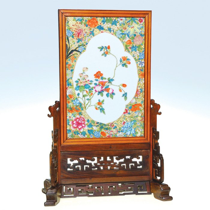 Chinese glass screen in wooden stand, 23 3/4”: Good Chinese glass table screen ornately enameled with a meandering flowering vine in the center and bordered with a busy design of assorted garden flowers set against a matte gold backdrop. The plaqu