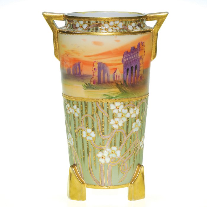 Nippon tri-footed vase, Grecian ruins, floral, 8: Nippon tri-footed vase displaying an all around panel of Grecian ruins silhouetted against an eventide sky, the scene framed by white flowers in thick enamel laid over a green backdrop with hanging le