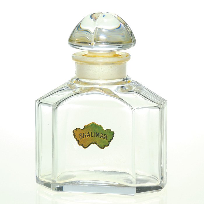 Baccarat Shalimar Guerlain perfume, stopper,4 3/8": Guerlain “Shalimar” crystal perfume bottle, a design by Baccarat. Original “Shalimar” paper sticker. Frozen stopper. Height 4 3/8 inches. Stamped “Guerlain, Paris, France, Bottle Made in Fra