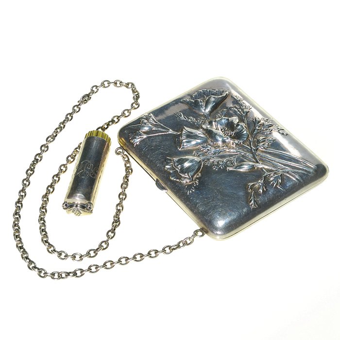 2 sterling:Jenson 2” lipstick + change purse: Two sterling items: 1) A Georg Jensen 2 inch lipstick case with pine cone and leaf application. Marked “Georg Jensen , Inc, USA Sterling”. Usage dents. 2) A change purse 3 inch by 3 1/2 inch with 
