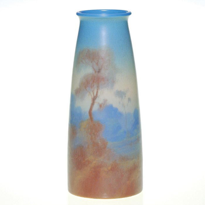 Rookwood Scenic Vellum 9 5/8” vase, Rothenbusch: Vellum landscape vase decorated by Fred Rothenbusch in 1916 with a view of trees above a misty valley. Impressed with the Rookwood symbol, the date, shape 1660 D and a V for Vellum and incised with Mr