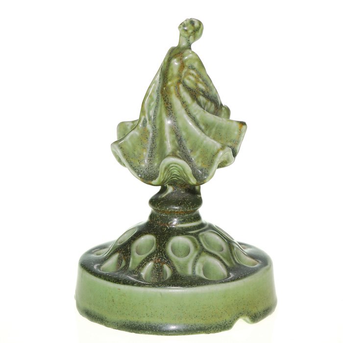 Rookwood mat “Dancer” 6 7/8” flower frog, 1923: Graceful Ballerina flower holder, designed by Louise Abel, cast in 1923 and covered with a mat gray green glaze with some crystals. Impressed with the Rookwood logo, the date and shape 2538. There is 