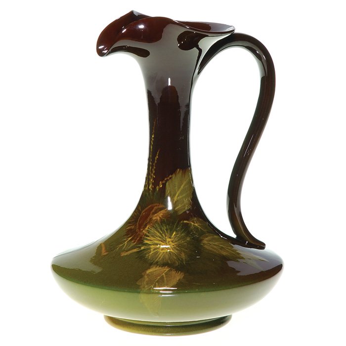 Rookwood Standard ewer, chestnuts, Sax, 1899,: Standard glaze ewer with chestnut decoration done in 1899 by Sara Sax. Marks include the company logo and date, shape number 606 B, a diamond shaped paper label from “A.D. Norton Jeweler, Gloversvil