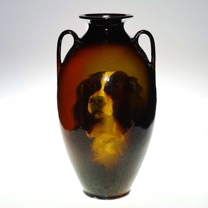 Roseville Rozane 21” “Dog Portrait” vase: Roseville Rozane vase with two handles, decorated by Claude Leffler who painted a sensitive portrait of an English Spaniel on the vessel. Impressed on base “Rozane 826 RPO 3 A B” and signed “C.L