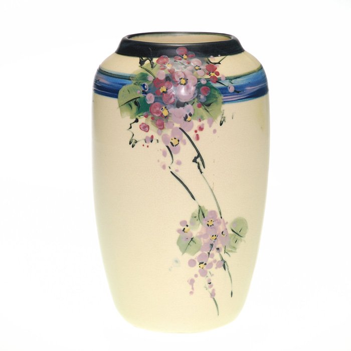 Weller White and Decorated, blue band, floral, 7 3/8”: Weller White and Decorated vase displaying violet bouquets both front and back connected by a blue band. Height 7 3/8 inches. Impressed “Weller”. Beautiful artwork, excellent condition.
