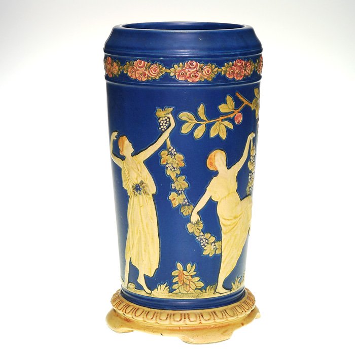 Weller Blue Ware lamp vase, dancing women, 13”: Weller Blue Ware lamp vase with their usual array of dancing women carrying garlands of grapes. Happy hour at Humler & Nolan. Impressed Weller in large block letters. Height 13 inches. Good color and 