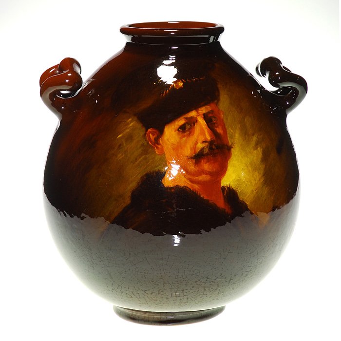 Owens Utopian vase, after Rembrandt, A.F. Best, 12 1/2”: Colossal Owens Utopian vase with generous size handles done with a classic self portrait of Rembrandt, clothed for winter weather wearing a fur hat and a fur collar jacket, the work of artist A.F. Bes