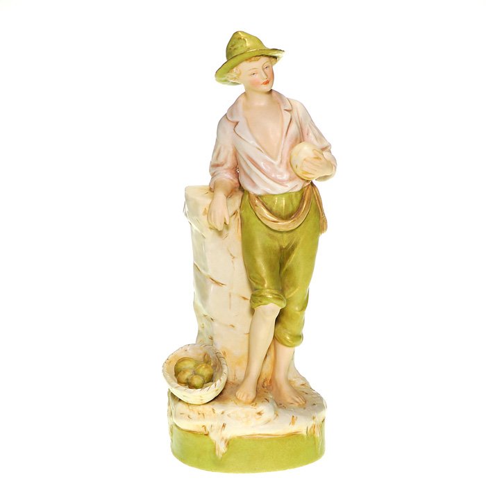 Royal Dux flower holder, 11” peasant boy: Royal Dux Bohemia “Peasant Boy” figure depicting a barefoot lad standing by a basket of vegetables, holding a cantaloupe while leaning against a stone wall. Bearing the raised Royal Dux Bohemia wa