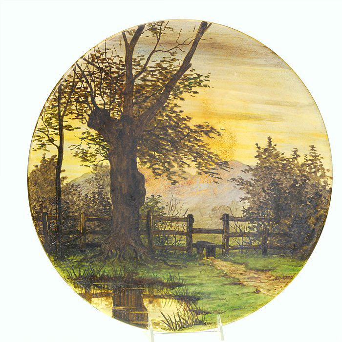 English 16” charger, landscape by W.J. Nelson: English charger decorated in 1881 by W.J. Nelson with a detailed landscape titled “A Quiet Pool.” Signed “W.J. Nelson” in slip on the back, impressed 16 IN and bearing a circular esoteric mark