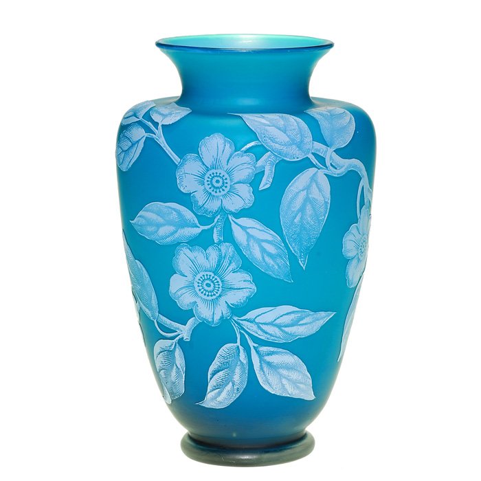 English cameo vase, blue, apple blossoms, 7 1/4”: English cameo vase, attributed to Stevens & Williams with several large whitish blue apple blossoms on a leafy branch over prussian blue. Opal cased interior. Height 7 1/4 inches. The detail work has 