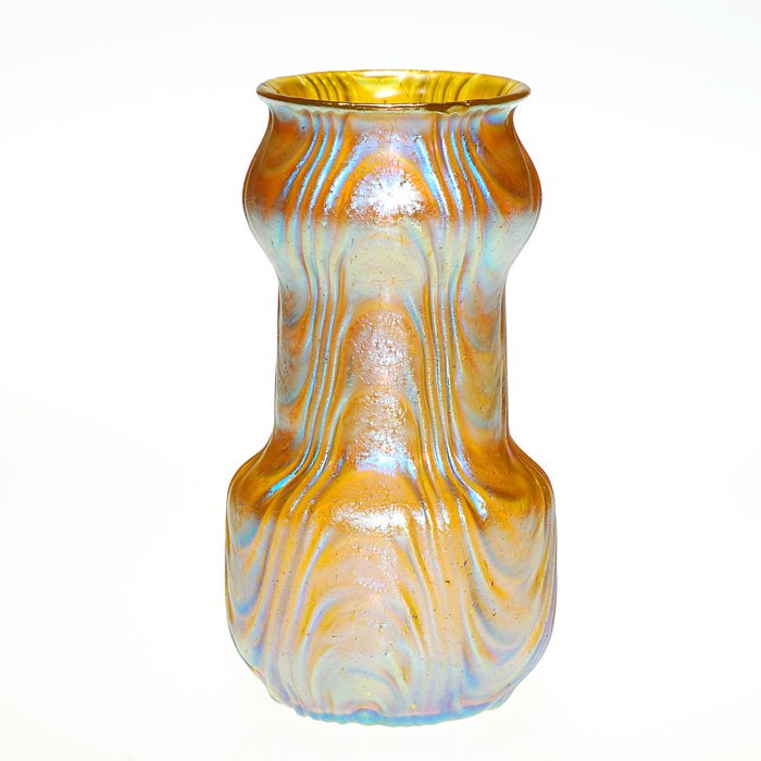 Loetz “Oceanik” vase, strong iridescence, 7”: Shapely Loetz vase with the undulating “Oceanik” pattern within the honey amber glass. The surface is slight of texture and has a brilliant bluish iridescence. Height 7 inches. Handsome and in exc