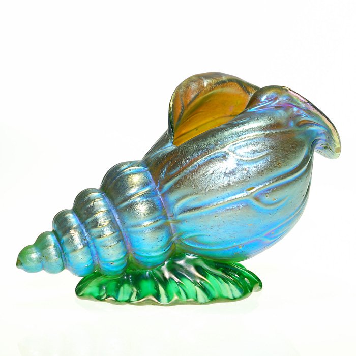Loetz Neptune shell, 3 1/2”X5 7/8”: Nice Loetz conch shell displaying the “Neptune” pattern in a nice mat blue positioned over a green wave. Height 3 1/2 inches by 5 7/8 inches long. Attractive and good size. Excellent condition.