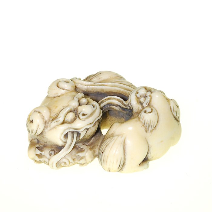 Japanese 19th Century netsuke, foo dogs, 5/8”: Japanese ivory netsuke of a playful Foo dog puppy with it’s mother. Measures 5/8 inches by 1 5/8 inches. Artist engraved possibly Hynd. Cute and in excellent condition.