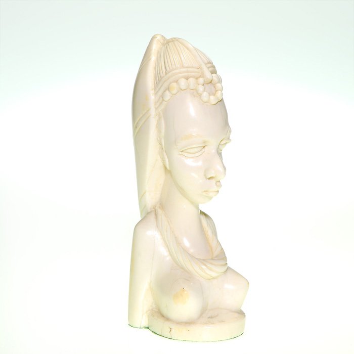 Carved Ivory Woman, Liberia ca. 1952, 7 7/8”: Carved Liberian ivory bust of a nude African woman wearing a hood 0556with beadwork, a necklace surrounding her neck, circa 1952. Height 7 7/8 inches. Natural inconsistencies to the ivory. Nicely carv