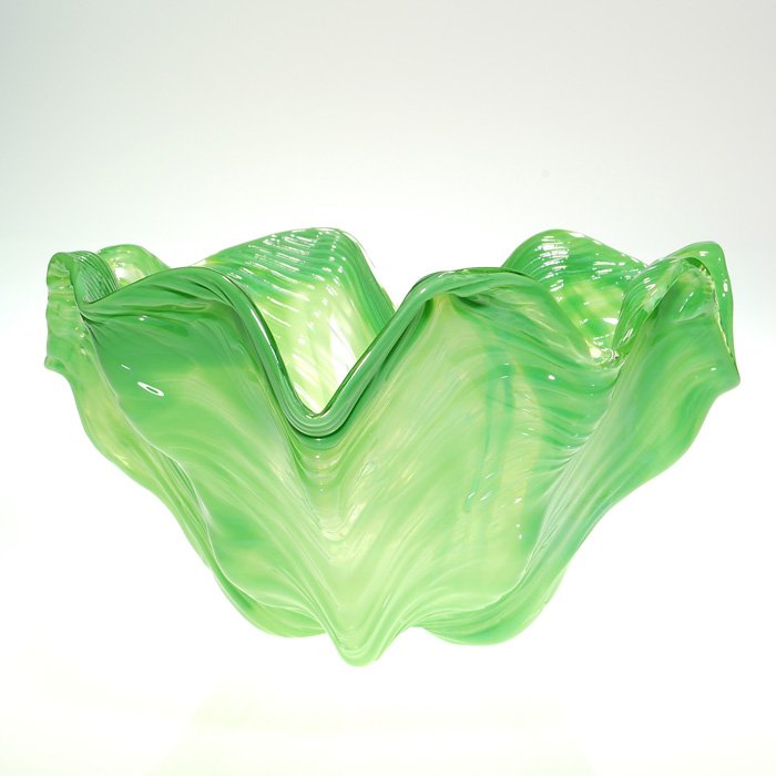 Large Venini “cabbage” bowl, green, swirl, 7 1/2”, sig: Large Venini “cabbage” bowl having a ribbed swirl body in variegated greens. Height 7 1/2 inches, diameter 13 1/2 inches. Engraved “Murano Italy” on the bottom. Interior mineral stains.