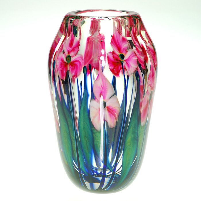 John Lotton Paperweight vase, 1994, 8 3/8”, signed: John Lotton paperweight vase arranged with trillium-like flowerheads in pinky red set atop blackened stems enclosed by layers blue green foliage. Height 8 3/8 inches. Artist signed on the side of the 