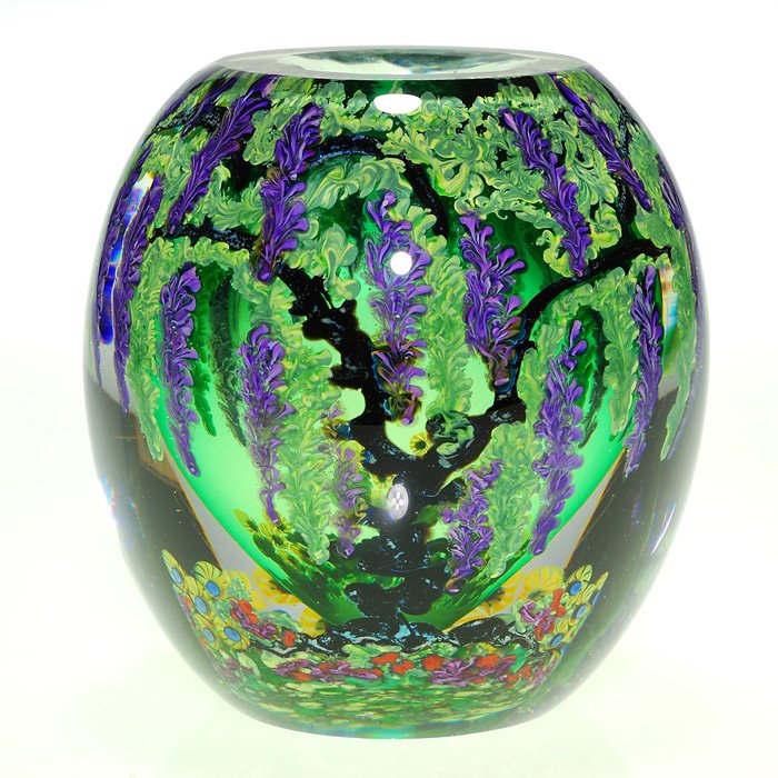 Chris Heilman “Wisteria Garden” vase, 5 1/4”, signed: Beautiful Chris Heilman paperweight vase lush with a “Wisteria Garden” in perpetual bloom. The pendulous vines flourish above an old fashion flower garden ablaze in color. A clear emerald green co