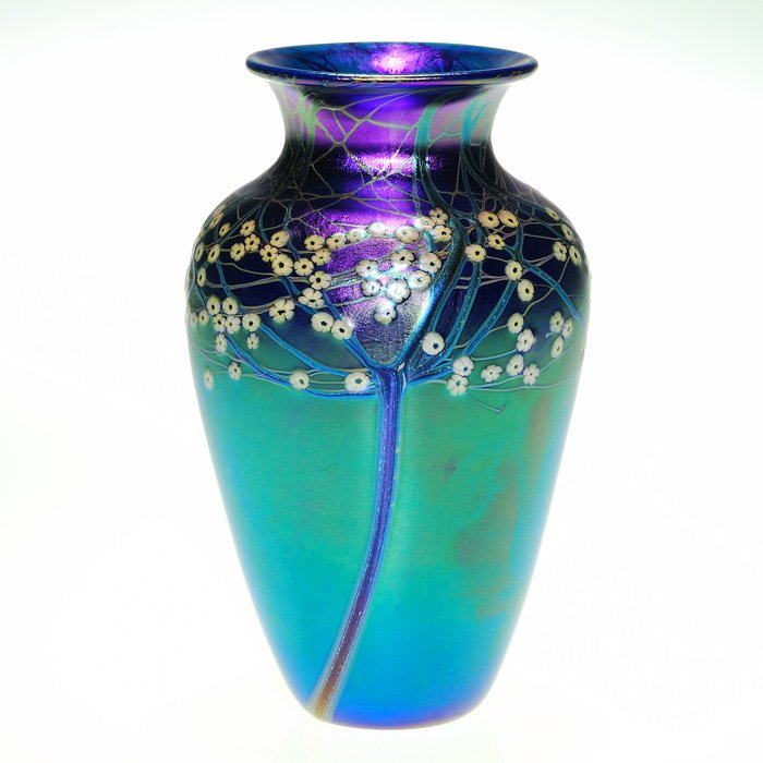 Orient & Flume vase, millefiori trees, 6 3/4”, signed: Good Orient & Flume Aurene blue vase showing slender trees, their branches entwined and dotted with tiny white millefiori Hawthorne flowers. Height 6 3/4 inches. Bright reddish purple iridescence enci