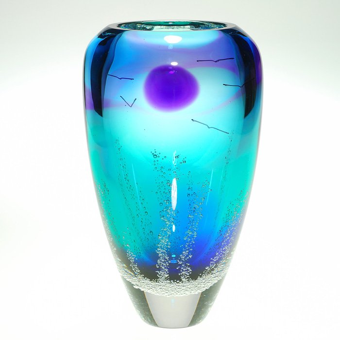 Waldo “Buzz” Blodgett “Moon” Vase, 9”, signed, 1995: Interesting Waldo “Buzz” Blodgett paperweight vase showing a night scene with a large purple “moon” encircled by several seagulls and a bizarre display of bubbly columns rising to greet the sk