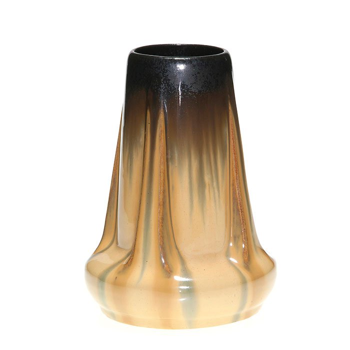 Fulper Buttress vase, Mirror Black glaze, 8 1/4”: Fulper Pottery 8 1/4 inch buttress vase covered in a tan flambe’ glaze over which the Mirror Black glaze has been dripped from the rim. Marked on the bottom with the Fulper racetrack ink stamp. Ther