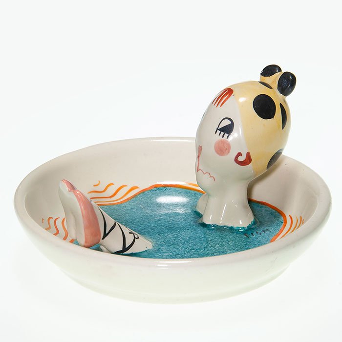 Fulper Novelty dish, bather, Fish, 2 3/4” X 5”: Fulper Pottery porcelain novelty dish of a female bather, the work of Anne Fish who has signed the piece in black slip on the blue water. Size is 2 3/4 inches high by 5 inches in diameter. Marked on t